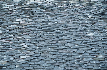 Old gray stone roof on house