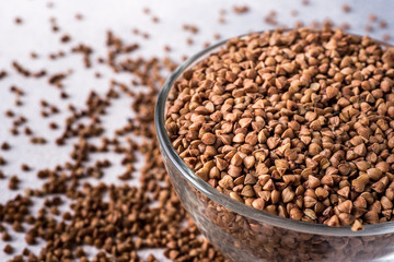  healthy buckwheat in a bowl isolated on gray background close-up with place for text