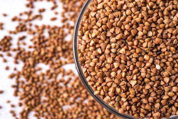  healthy buckwheat in a bowl isolated on gray background close-up with place for text