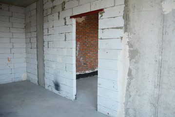 Interior room under construction with metal door lintels. Autoclaved aerated concrete  wall without plasterwork.