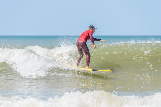 surf instructor decides to join his advanced class in the water. Surf instructor in action
