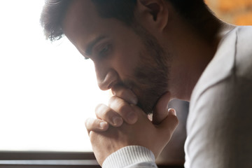 Close up of pensive male thinking of personal problems