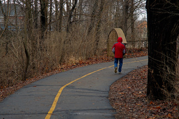 A person walks alone down an improved river bluff trail in Logansport Indiana