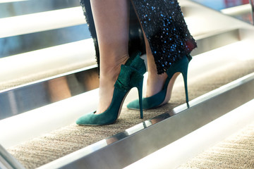 womens green suede high-heeled shoes with decorative rhinestones trim on the legs of the model