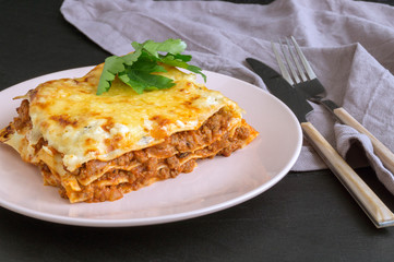 Meat lasagna on a wooden background.