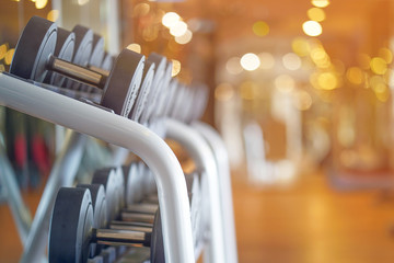Rows of dumbbells in the gym. Toning.