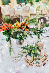 Floral details of the centerpiece of a retro-style wedding restaurant.