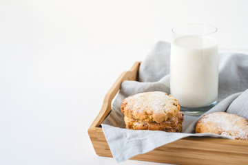 Stacked cookies on a linen napkin and a glass of milk. Close up.