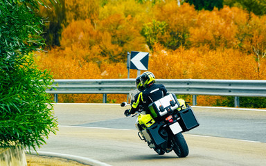 Motorcycle on road at in Sardinia Island in Italy in summer. Motorcyclist driving scooter on...