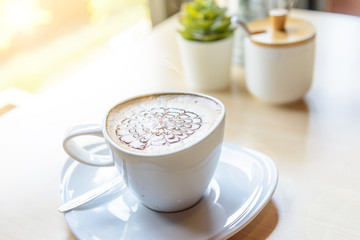 hot coffee with sunflower field on background