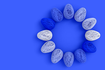 Obraz na płótnie Canvas Easter concept. On an blue background a lot of eggs woven from intertwined all shades of blue and white threads laid out in a circle with an empty space in the center. 3D stock illustration.