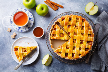 Apple pie on a cooling rack. Grey background. Copy space. Top view.