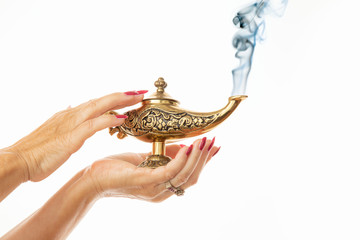 woman hands wiping a magic lamp on white background