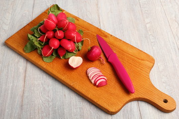 Radish on wooden cutting board