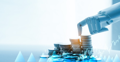 AI(Artificial Intelligence) and Financial Technology concept.Robot Hand Stacking pile of...