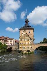 Fototapeta na wymiar Bamberg, Germany - July 15, 2019; Center of Bamberg a popular tourist destination with ancient center with bridges, flowers and timbered houses in a vertical image