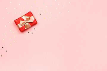 Creative Valentine's Day greeting card with red decorations and gift boxes, golden heart confetti...
