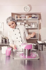 woman pastry chef prepares and decorates cake