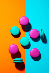 Macaroons dessert on colorful background. Top view.