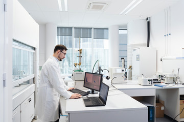 Scientist using computer in laboratory of technology center