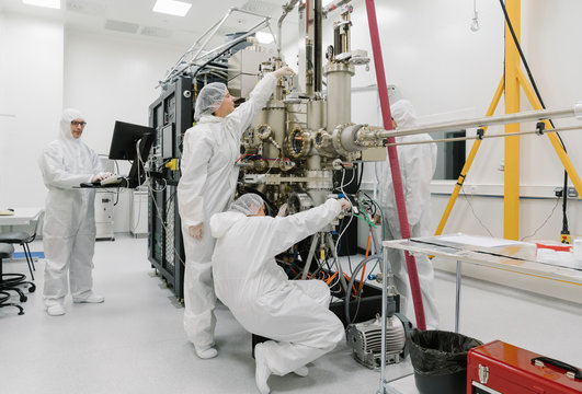 Laboratory technicians working on a device in laboratory of science center
