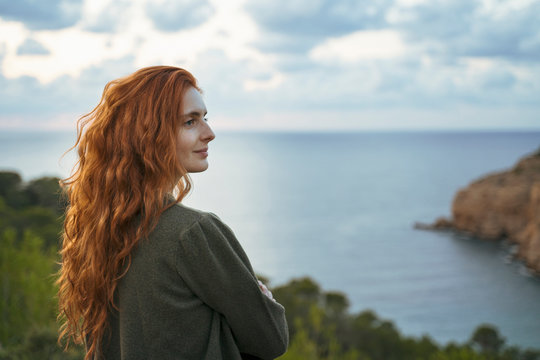 Redheaded young woman at the coast, Ibiza, Spain