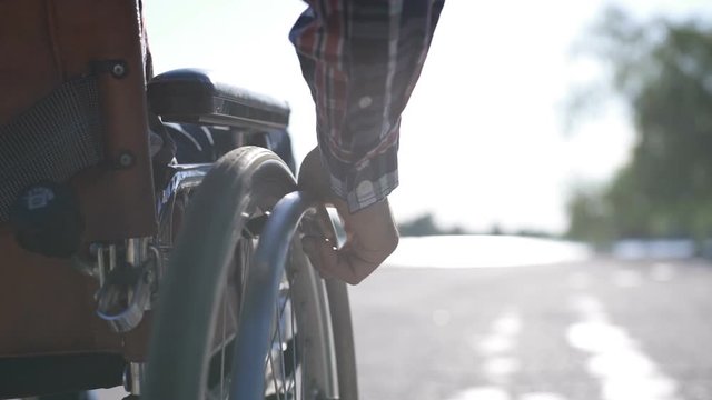 A man in a wheelchair walks on the waterfront