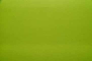 The texture of the green material, fabric. Background from white, beige pattern material.