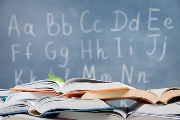 Books collection on a school board background.