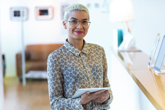 Portrait of confident businesswoman holding tablet in office