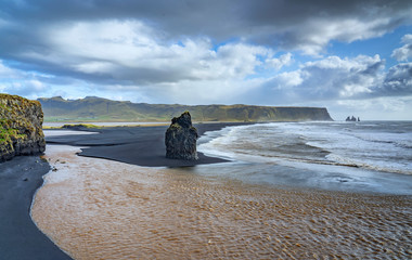 volcanic rock formation of Dyrholaey near Vik in stormy weather southern Iceland