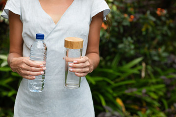 Choosing between plastic bottle and glass bottle. Zero waste concept. Green and conscious lifestyle concept.