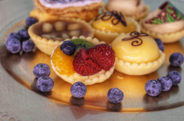 plate with mini cakes and blueberries