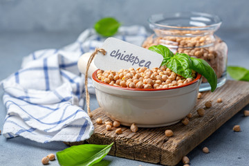 Dry chickpea seeds in a ceramic bowl.
