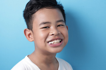 Cute Asian boy eating bubble gum and blow balloon