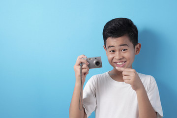 Happy Asian boy doing photography