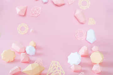 polygonal diamonds made of paper on a pink background