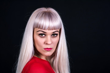 Naklejka premium A woman with blond hair, wearing a tight dress. Close-up portrait.