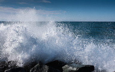 Blue waves crashing on a rocky shore