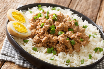 Taiwanese braised pork over rice with boiled egg close-up in a plate on the table. horizontal