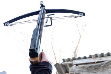 Crossbow in the hands. Shot in the sky. Weapons Strength and authority. Power.