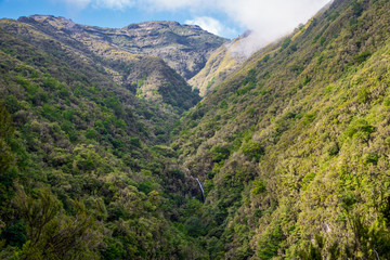 Fototapeta na wymiar Caldeirao Verde waterfall with mountain landscape on the Levada Caldeirao Verde near Santana on the island of Madeira, Portugal.