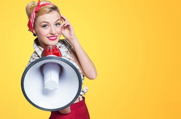 Portrait of woman holding megaphone, dressed in pin-up style