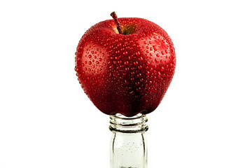 red Apple in drops of water on the neck of the bottle. the concept of abstinence from alcohol....