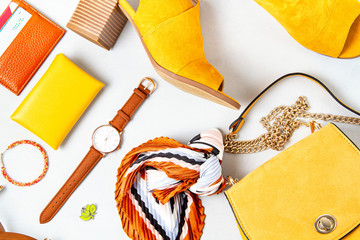 Flat lay with woman fashion accessories in yellow colors. Fashion blog, summer style, shopping and trends idea