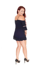 Gorgeous woman standing from the back in a black dress