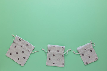 Cotton bags for free plastic shopping on a green background. Copy space.