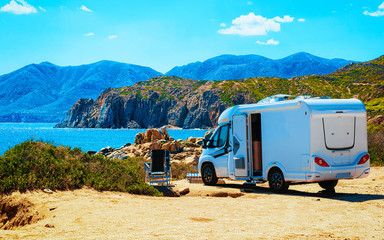 Camper on road at Capo Pecora at Mediterranean sea in Sardinia Island, Italy summer. Caravan...