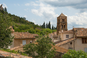Fototapeta na wymiar Church and roofs of houses of a historic popular tourist village of Moustiers Saint Marie