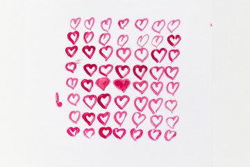 Greeting card for Valentine's Day. Pink hearts painted with watercolor paints